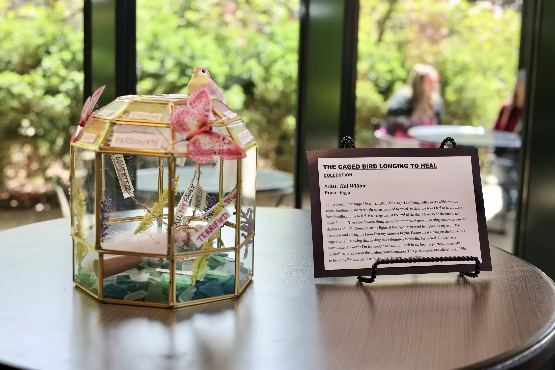 Artwork display titled The Caged Bird Longing To Heal at the Reclaim 13 event